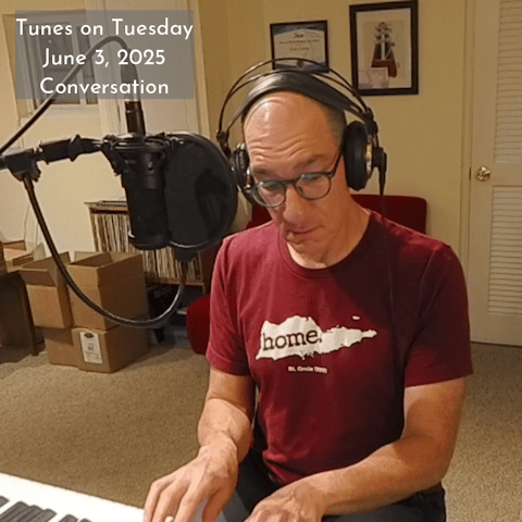 Photo of Oren Levine playing an electric piano. He is wearing a St. Croix t-shirt and headphones. Text at upper left reads 'Tunes on Tuesday June 3, 2025 Conversation'