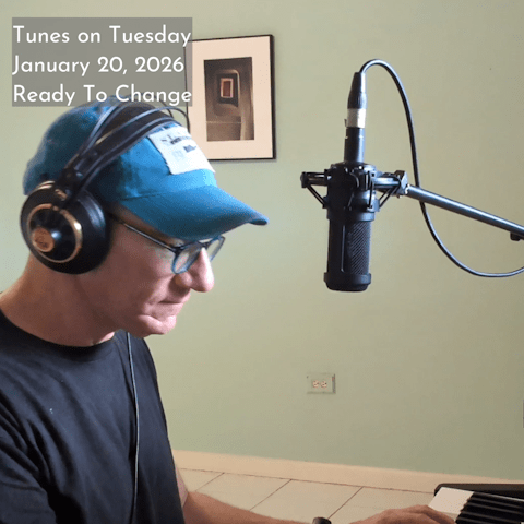 Photo of Oren Levine playing an electric piano and singing in to a microphone suspended above the keyboard. Text at top left reads 'Tunes on Tuesday January 20, 2026 Ready To Change'