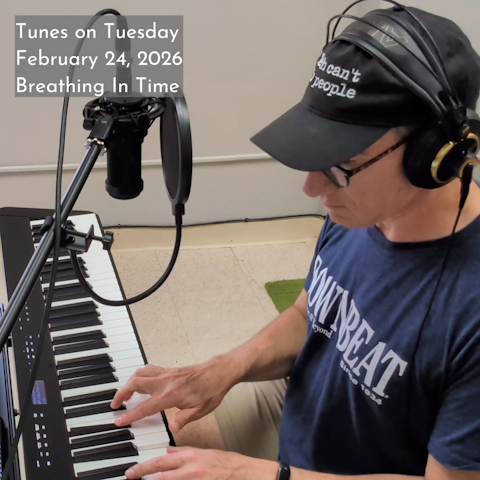 Photo of Oren Levine playing an electric piano. He wears headphones over a ball cap. Text at top left reads 'Tunes on Tuesday February 24, 2026 Breathing In Time'